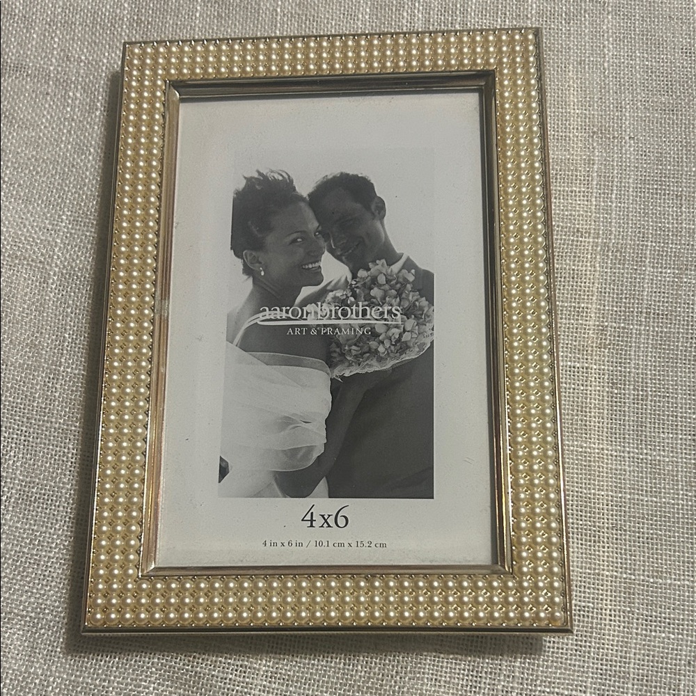 Gold Frame with pearls.